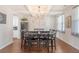 Elegant dining room with dark wood table and chairs, chandelier, and coffered ceiling, ideal for gatherings at 143 Airy Dr, Summerville, SC 29486