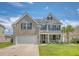 Charming two-story home featuring a brick facade, shuttered windows, and palm tree at 143 Airy Dr, Summerville, SC 29486