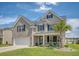 Charming two-story home with a brick and siding facade, a manicured lawn and an attached two-car garage at 143 Airy Dr, Summerville, SC 29486