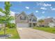Two-story home with brick facade, shutters, two-car garage, and inviting front porch at 143 Airy Dr, Summerville, SC 29486