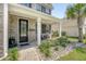Inviting front porch with brick accents, decorative plants, and welcoming decor creates a charming entrance at 143 Airy Dr, Summerville, SC 29486