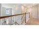 Bright hallway featuring natural light, wood-and-white banister, leading to the home's entrance at 143 Airy Dr, Summerville, SC 29486