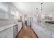 Well-lit kitchen featuring a subway tile backsplash, an island with bar seating, and stainless appliances at 143 Airy Dr, Summerville, SC 29486