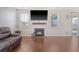 Bright living room with fireplace and large windows, creating a welcoming and comfortable atmosphere for gatherings at 143 Airy Dr, Summerville, SC 29486