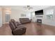 Cozy living room with a fireplace, large windows, hardwood floors, and comfortable seating at 143 Airy Dr, Summerville, SC 29486