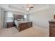 Spacious main bedroom with a tray ceiling, carpeted floors, large windows, and elegant furnishings at 143 Airy Dr, Summerville, SC 29486