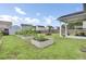 Landscaped backyard featuring garden beds, a shed, and a covered patio with string lights at 145 Woodbrook Way, Moncks Corner, SC 29461