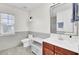 Bathroom features vanity with storage, large mirror, modern fixtures, and a window at 145 Woodbrook Way, Moncks Corner, SC 29461