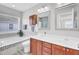 Well-lit bathroom with double vanity, soaking tub, and tiled shower offering a spa-like experience at home at 145 Woodbrook Way, Moncks Corner, SC 29461