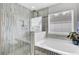 Bright bathroom showcases a glass-enclosed shower, soaking tub, and decorative tile, creating a luxurious feel at 145 Woodbrook Way, Moncks Corner, SC 29461