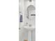 Stylish pedestal sink in bathroom, featuring a round mirror and chrome hardware at 145 Woodbrook Way, Moncks Corner, SC 29461
