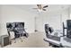 This carpeted bedroom features neutral walls, a ceiling fan, and two desks for working at 145 Woodbrook Way, Moncks Corner, SC 29461