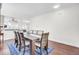 Open dining room featuring a long table with seating for ten, hardwood floors, and bright natural light at 145 Woodbrook Way, Moncks Corner, SC 29461