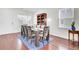 Formal dining room featuring a large table set for ten, hardwood floors, and a bookshelf at 145 Woodbrook Way, Moncks Corner, SC 29461