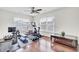 Bright exercise room features wood floors, a ceiling fan, and large windows providing natural light for at-home workouts at 145 Woodbrook Way, Moncks Corner, SC 29461