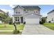 Charming two-story home with a well-maintained lawn and a spacious two-car garage at 145 Woodbrook Way, Moncks Corner, SC 29461