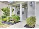Inviting front porch with decorative hanging plants and a stylish entrance at 145 Woodbrook Way, Moncks Corner, SC 29461