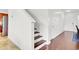 Entryway with hardwood floors, leading to the staircase and kitchen at 145 Woodbrook Way, Moncks Corner, SC 29461