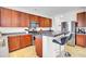 Open concept kitchen with wood cabinets, stainless steel appliances and tiled breakfast bar at 145 Woodbrook Way, Moncks Corner, SC 29461