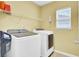 Bright laundry room with washer, dryer, shelving, and a window at 145 Woodbrook Way, Moncks Corner, SC 29461