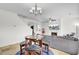 Cozy living room with fireplace, TV, chandelier and a round breakfast table at 145 Woodbrook Way, Moncks Corner, SC 29461