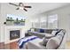 Cozy living room boasts a fireplace, large sectional, and a TV displaying a fountain view at 145 Woodbrook Way, Moncks Corner, SC 29461