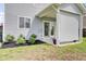 Covered patio features vinyl siding, landscaping, and a sliding glass door at 145 Woodbrook Way, Moncks Corner, SC 29461