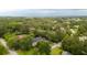 Aerial view of a home nestled among lush trees in a quiet neighborhood setting at 1511 Fairway Dr, Charleston, SC 29412