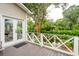 Spacious back porch overlooking garden with decorative railing and view of outdoor space at 1511 Fairway Dr, Charleston, SC 29412
