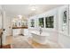 Bright bathroom featuring a soaking tub and a vanity with stone countertops at 1511 Fairway Dr, Charleston, SC 29412