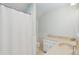 Bright bathroom with white wainscoting, hexagon tile flooring, and a shower curtain at 1511 Fairway Dr, Charleston, SC 29412