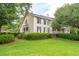 Well-maintained home featuring lush landscaping, mature trees, and classic architectural details at 1511 Fairway Dr, Charleston, SC 29412