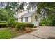 Charming home featuring a well-manicured lawn, mature landscaping, and a two-car garage at 1511 Fairway Dr, Charleston, SC 29412