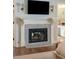 Main bedroom fireplace with marble surround flanked by sconces and a TV, located off the en suite bathroom at 1511 Fairway Dr, Charleston, SC 29412