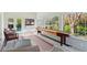 Bright sunroom with large windows, natural light, and a shuffleboard game table, perfect for relaxation and entertainment at 1511 Fairway Dr, Charleston, SC 29412