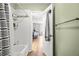 Bright bathroom features a shower-tub combo and a view of the bedroom beyond at 1530 Fort Johnson Rd # 1L, Charleston, SC 29412