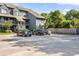 View of a two-story condominium complex with gray siding and convenient parking spaces at 1530 Fort Johnson Rd # 1L, Charleston, SC 29412