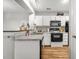 Functional kitchen featuring a granite countertop, white cabinets, and modern appliances at 1530 Fort Johnson Rd # 1L, Charleston, SC 29412