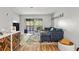 Comfortable living room featuring hardwood floors, a blue sofa, and a sliding door to the balcony at 1530 Fort Johnson Rd # 1L, Charleston, SC 29412