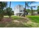 View of home's rear elevation showing the porch, stairs, and yard at 1577 Periwinkle Dr, Mount Pleasant, SC 29466