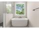 Bathroom featuring a soaking tub with black fixtures next to a window and a glass shower at 1577 Periwinkle Dr, Mount Pleasant, SC 29466