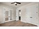 This bedroom features hardwood floors, a ceiling fan, closet and glass paneled doors at 1577 Periwinkle Dr, Mount Pleasant, SC 29466