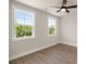 Well-lit bedroom featuring modern ceiling fan and two large windows at 1577 Periwinkle Dr, Mount Pleasant, SC 29466