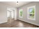 Bedroom features hardwood floors, a modern light fixture, and views of the outdoors at 1577 Periwinkle Dr, Mount Pleasant, SC 29466