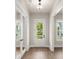 Bright entryway featuring wood floors, white trim, and a glass-paneled door at 1577 Periwinkle Dr, Mount Pleasant, SC 29466