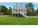 Beautiful white home with a spacious front yard and inviting porch at 1577 Periwinkle Dr, Mount Pleasant, SC 29466