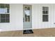 Charming home exterior with a light blue door, white siding, and a cozy welcome mat at 1577 Periwinkle Dr, Mount Pleasant, SC 29466