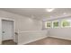 Upstairs hallway with recessed lighting, a white railing, and a three-panel window at 1577 Periwinkle Dr, Mount Pleasant, SC 29466