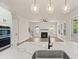 Bright kitchen view from island of fireplace, living room, and stairwell at 1577 Periwinkle Dr, Mount Pleasant, SC 29466