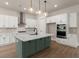 Modern kitchen with white cabinetry, stainless steel appliances, and a large island with pendant lighting at 1577 Periwinkle Dr, Mount Pleasant, SC 29466